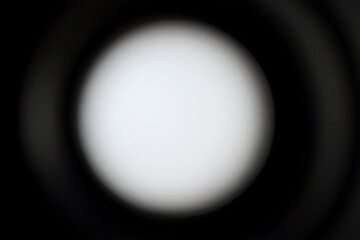 Abstract bright white oval shape against a dark background