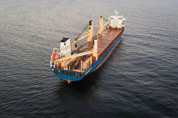 Aerial drone view of a large empty bulk carrier cargo ship navigating the calm waters of the Baltic Sea, Estonia.