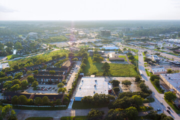 Panoramic view of Houston suburban area in Harris County, Texas, residential buildings, parking lots, green spaces, urban infrastructure commercial residential wide roadways.