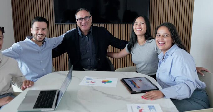 Multi generational business people celebrating success inside modern corporate office - Job, support and multiracial team concept 
