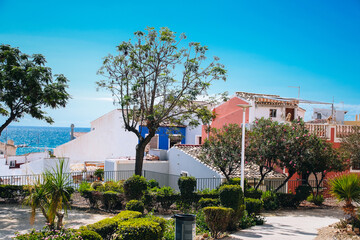 Villajoyosa street with typical colorful houses and view to Mediterranean Sea. La Vila Joiosa city, Alicante province, Spain