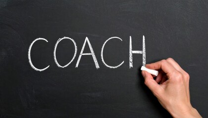 Fototapeta premium The word coach being written in chalk on a blackboard, symbolizing mentorship, guidance, training, education, and professional support