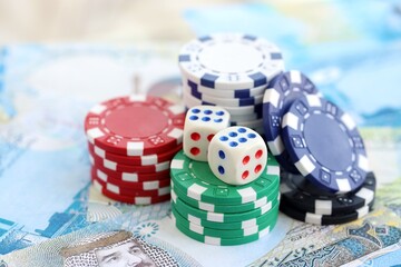 Bahraini dinar currency money bills and casino chips with dices. The concept of gambling and poker casino games