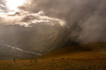 Sunlight Breaking Through Storm Clouds Over The Caucasus Mountains Near Ushguli Georgia: Dramatic Landscape Of Light, Shadow And Wilderness