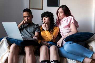 Diverse friends attending online meeting together on laptop