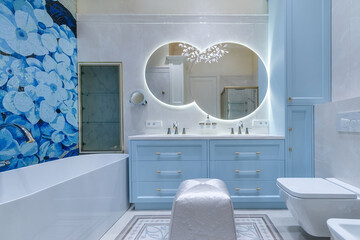 Elegant bathroom design featuring blue accents, modern fixtures, and floral decor in a serene setting