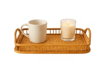 Wicker tray with mug and lit candle for relaxing