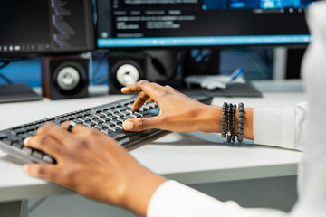 Close up of IT expert typing on PC keyboard in server hub with hardware supporting data mining. Computer scientist working in data center to do maintenance on rigs using device