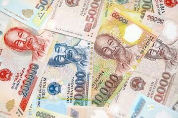 Vietnamese dong currency money bills. The current banknotes lies on table in big amount close up