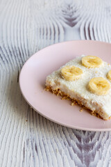 Close-Up of a Banana Coconut Cream Cake on a Pink Plate
