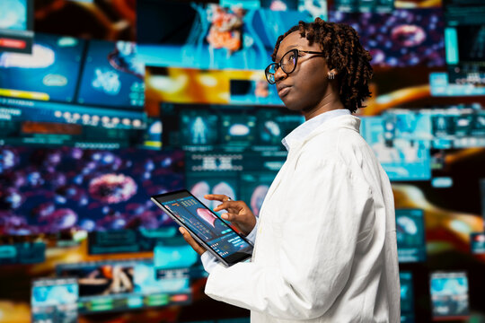 Doctor doing scientific research, analyzing human body on tablet to support medical developments. Biomedicine specialist reviewing organs on device using app, researching innovations