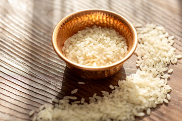 Close-Up of White Rice in a Mini Copper Cup on a Brown Wooden Table
