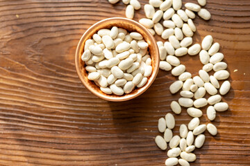 Close-Up of White Turkish-Style Beans in a Copper Cup on a Wooden Table
