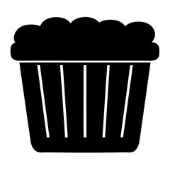 Black silhouette of a cupcake with frosting on a white background