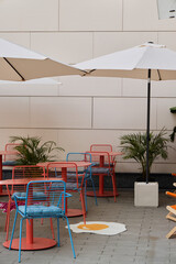 Colorful Outdoor Caf Setting with Umbrellas and Modern Furniture