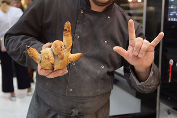 A baker holds his side in the shape of a hand
