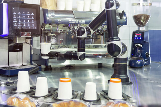 Robot with artificial intelligence making coffee on coffee machine