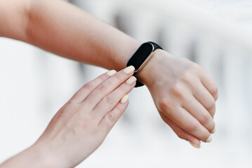 black fitness watch on young woman hand
