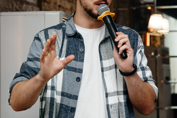 corporate presenter or event manager, young expressive gesticulating caucasian man speaking in...