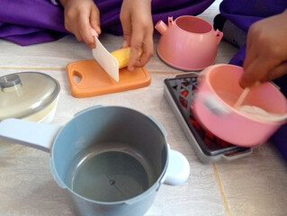 Children at kindergarten playing Cooking or playing house. 