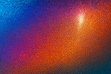 Vibrant macro close-up of flame-colored titanium surface with visible microtexture and reflective highlights