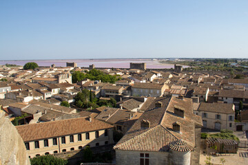 Obraz premium View of the ramparts, salt marshes, and medieval town of Aigues-Mortes from the Constance Tower in Aigues-Mortes Camargue France