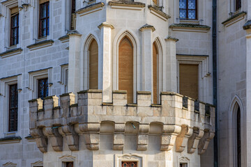Stone balcony and arched windows on historic european castle facade © Iurii Gagarin