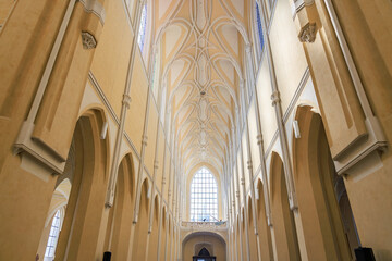 Gothic cathedral interior with arched ceilings and stained glass windows