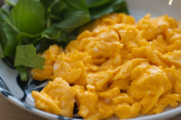 Homemade Scrambled Eggs and Fresh Green Salad for Breakfast