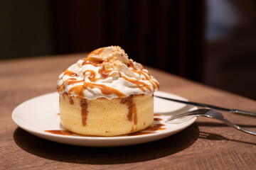 Caramel Pancake Dessert with Whipped Cream on Wooden Table