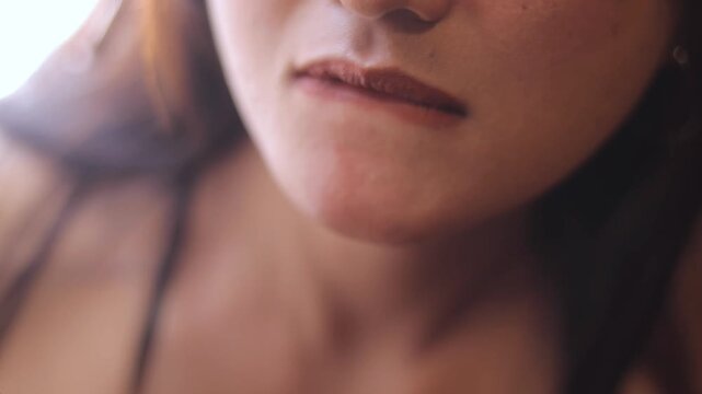 A compilation of subtle facial expressions, showcasing lip movements and delicate skin textures with warm lighting and