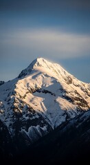 Snow-Capped Mountain Peak Bathed in Golden Sunlight.