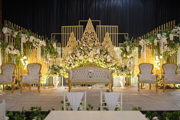 Elegant Wedding Ceremony Stage Decor with a Luxurious Gold and White Theme