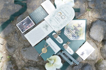 Elegant Wedding Invitation Suite with Floral Accents on Stone Background