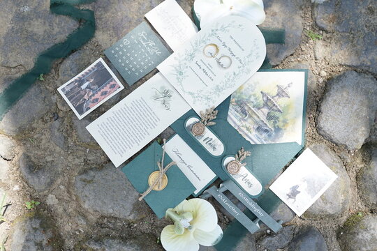 Elegant Wedding Invitation Suite with Floral Accents on Stone Background