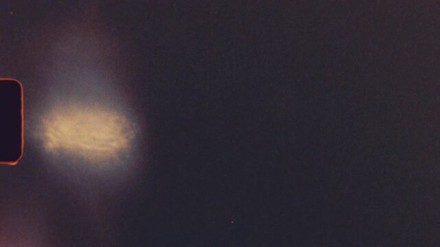 Dark retro film strip with intense red light leaks, scratches and dust particles in authentic super 8 style