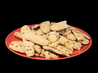 Chocolate-Dipped Cookies on a Red Plate Against a Black Backgrou