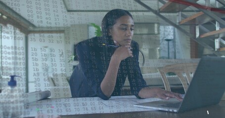 Analyzing code overlay, software engineer wearing blazer at home office with laptop documents, pen