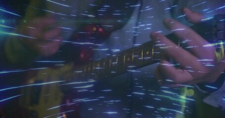 Playing musician hands in dark jacket fingering frets on yellow guitar on stage with blue streaks