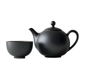 A minimalist black ceramic teapot and matching handleless cup with a matte, textured finish and brown rim detail. Ideal for sophisticated tea/coffee mockups or Asian themes.