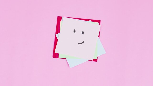 Video stop motion of stack colorful sticky note with message various expresion isolated on pink background