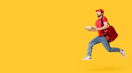 Running male courier holding pizza on yellow background with space for text