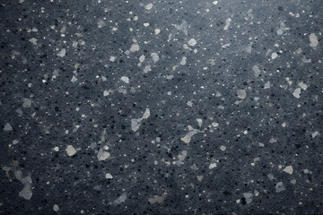 Diverse set of four abstract textures: dark green marble with white veins, speckled green quartz composite, dense green foam, and dark gray composite stone with white and gray specks.