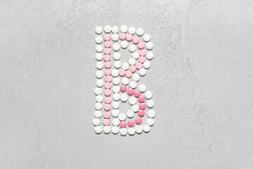 Vitamin B pills on grey background