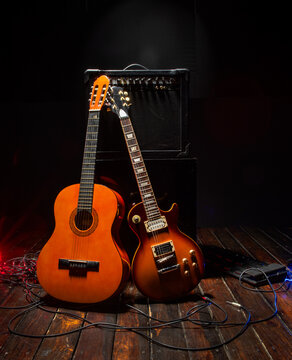 an amplifier and two guitars for background music