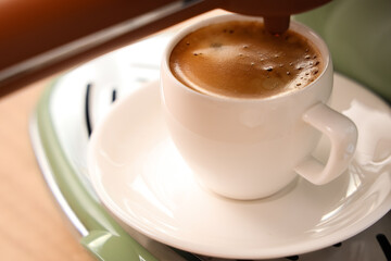 Modern coffee machine with cup of hot espresso, closeup