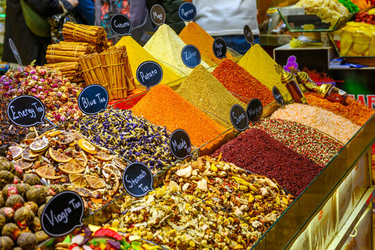 A market stall of colorful spices, herbs and teas inside the covered Spice Bazaar in Istanbul, Turkey.
