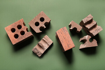 Broken bricks on green background