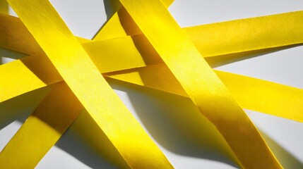 Bright yellow ribbons overlap and create a dynamic abstract pattern.
