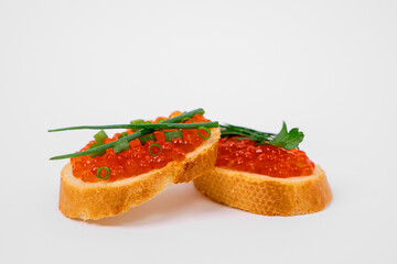 Elegant appetizer featuring salmon caviar roe on sliced baguette with herbs. perfect for gourmet dining, food presentations, and culinary inspiration.